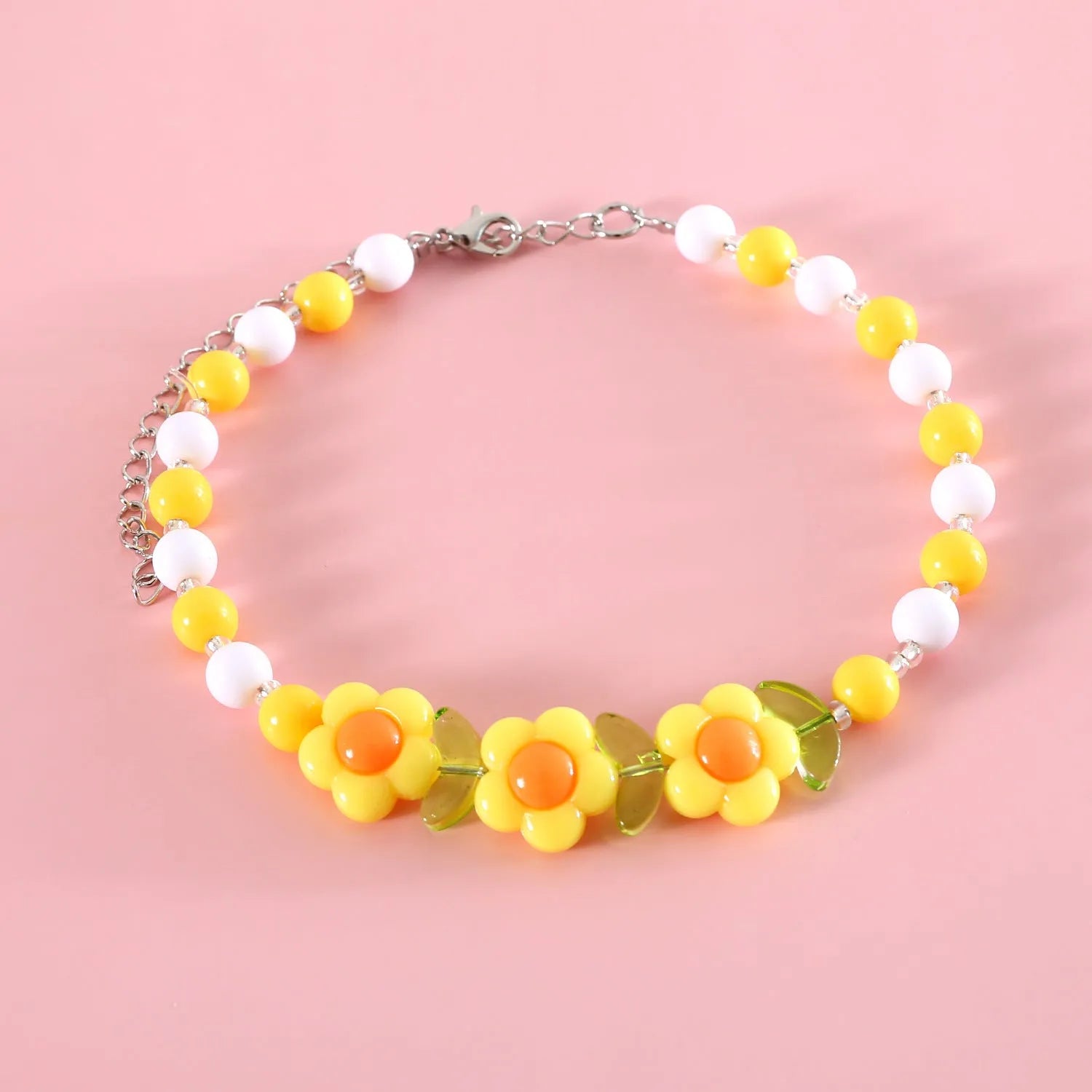 Colourful plastic bead cat necklace in small flower, rainbow, or peach design on adjustable cord.