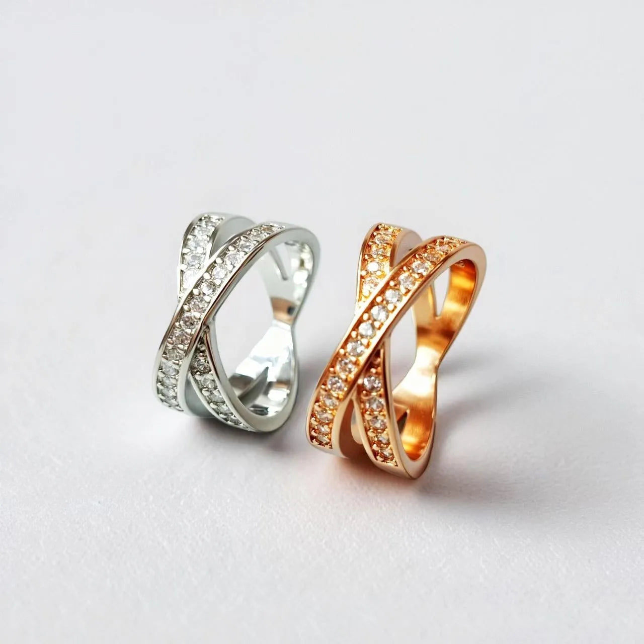 Geometric heart-shaped cross ring with micro-inlaid zircon on a copper base with silver or rose gold electroplated finish.