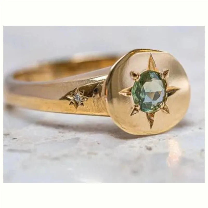 Golden oval ring with a star design and adjustable opening.