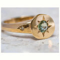 Golden oval ring with a star design and adjustable opening.