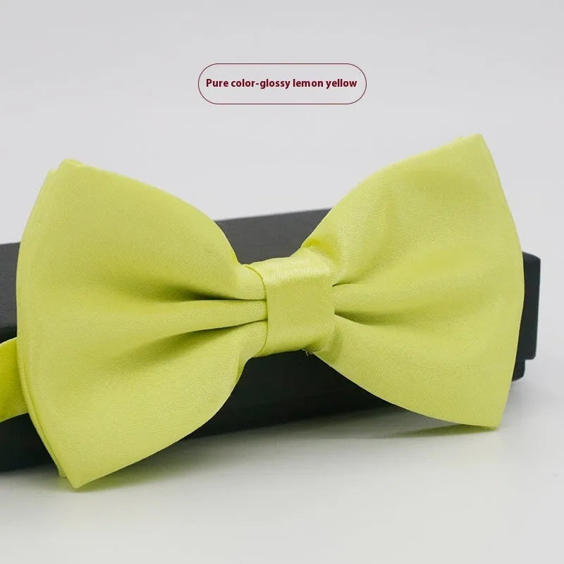 Solid colour flat head bow tie for formal wear in multiple colours including black, red, and blue.