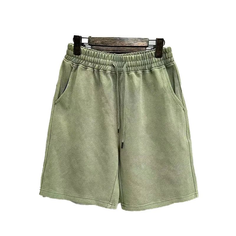 Men's solid colour distressed cotton shorts in a loose straight-leg casual fit.