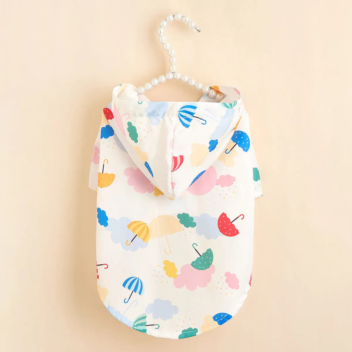 Colourful cartoon umbrella pattern pet raincoat for dogs or cats, available in sizes XS to XL.
