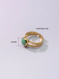 Copper adjustable ring with green natural stone inlay and gold-toned plating on white background