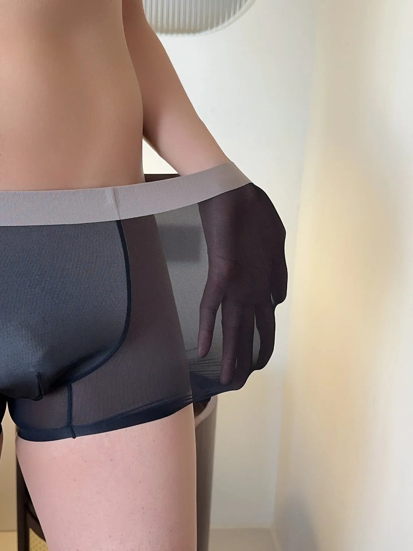 Seamless men's boxer shorts in ultra-thin ice silk nylon fabric, showing honeycomb crotch design.