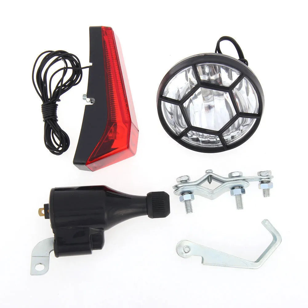 Silver bicycle dynamo generator light kit mounted on a bike frame with front and rear lights