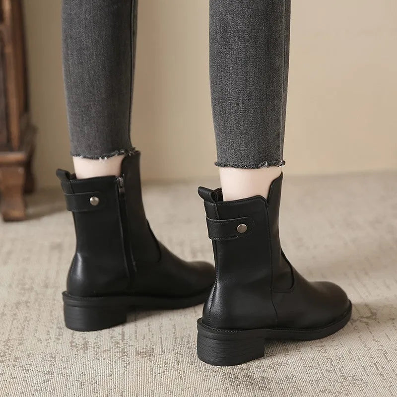 Black women's ankle boots with side zip, round toe, and a low block heel.