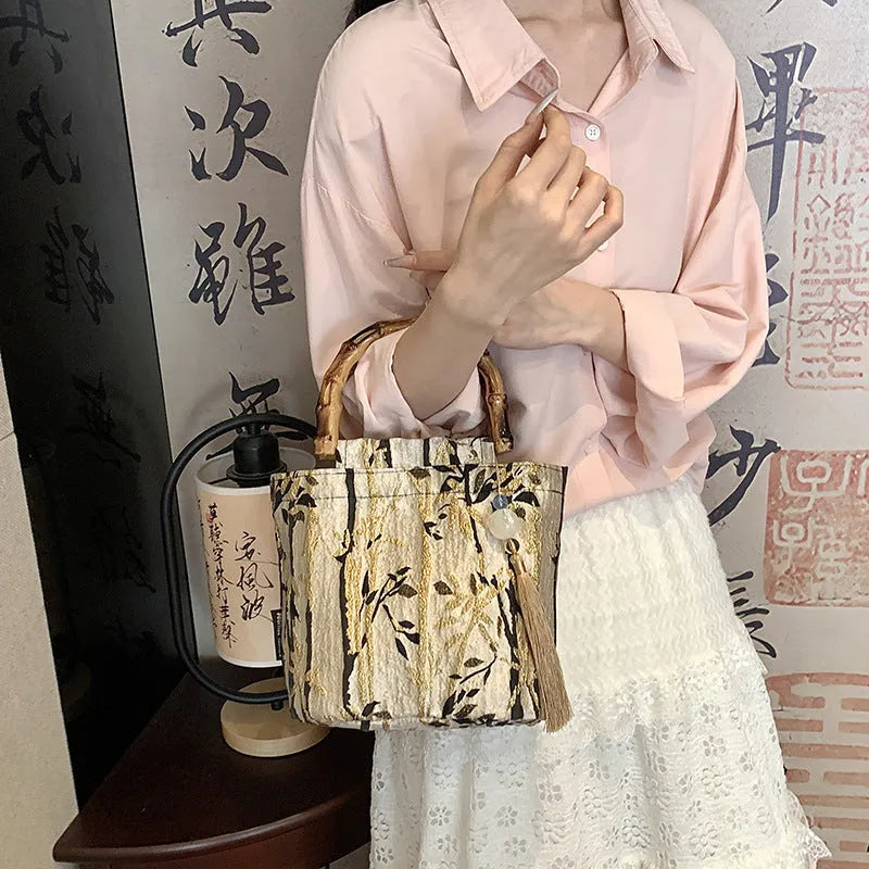 Beige women's handbag with bamboo handle and stitching detail, inner patch pocket, 19x27cm