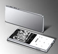 Black portable MP3 MP4 player with 2.4-inch touch screen showing music interface, placed on a desk.