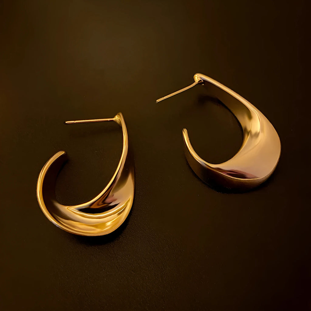 Twisted geometric metal hoop earrings in gold and silver electroplated colour options