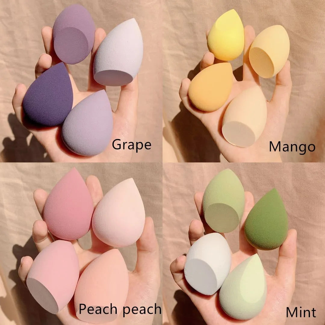 Four synthetic sponge makeup egg applicators in Grape, Mango, Mint, and Peach peach colours.