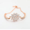 Rose gold cubic zirconia bracelet with cross crown Roman numeral motifs on alloy setting