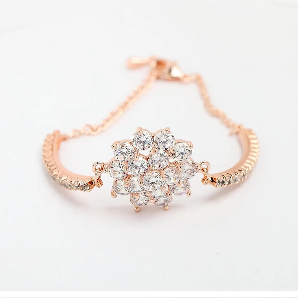 Rose gold cubic zirconia bracelet with cross crown Roman numeral motifs on alloy setting