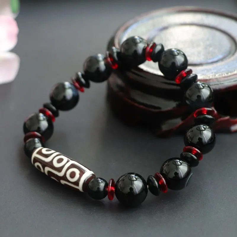 Black agate dzi bead bracelet with chalcedony stones in geometric design