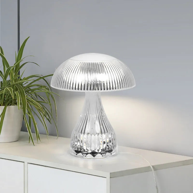 Small white rechargeable touch night lamp with acrylic body and plastic base on a wooden table.