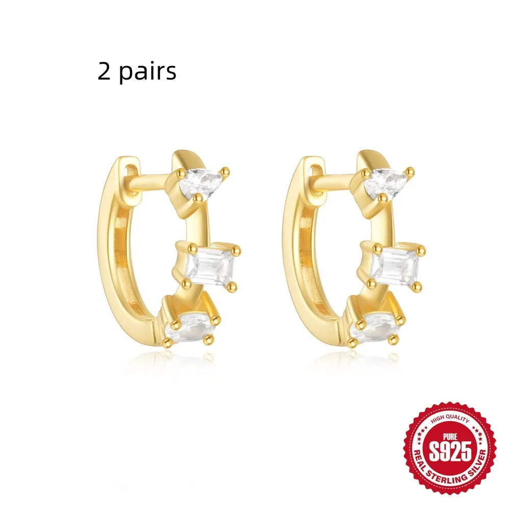 Sterling silver geometric stud earrings with round diamond accents in gold and silver electroplated finishes