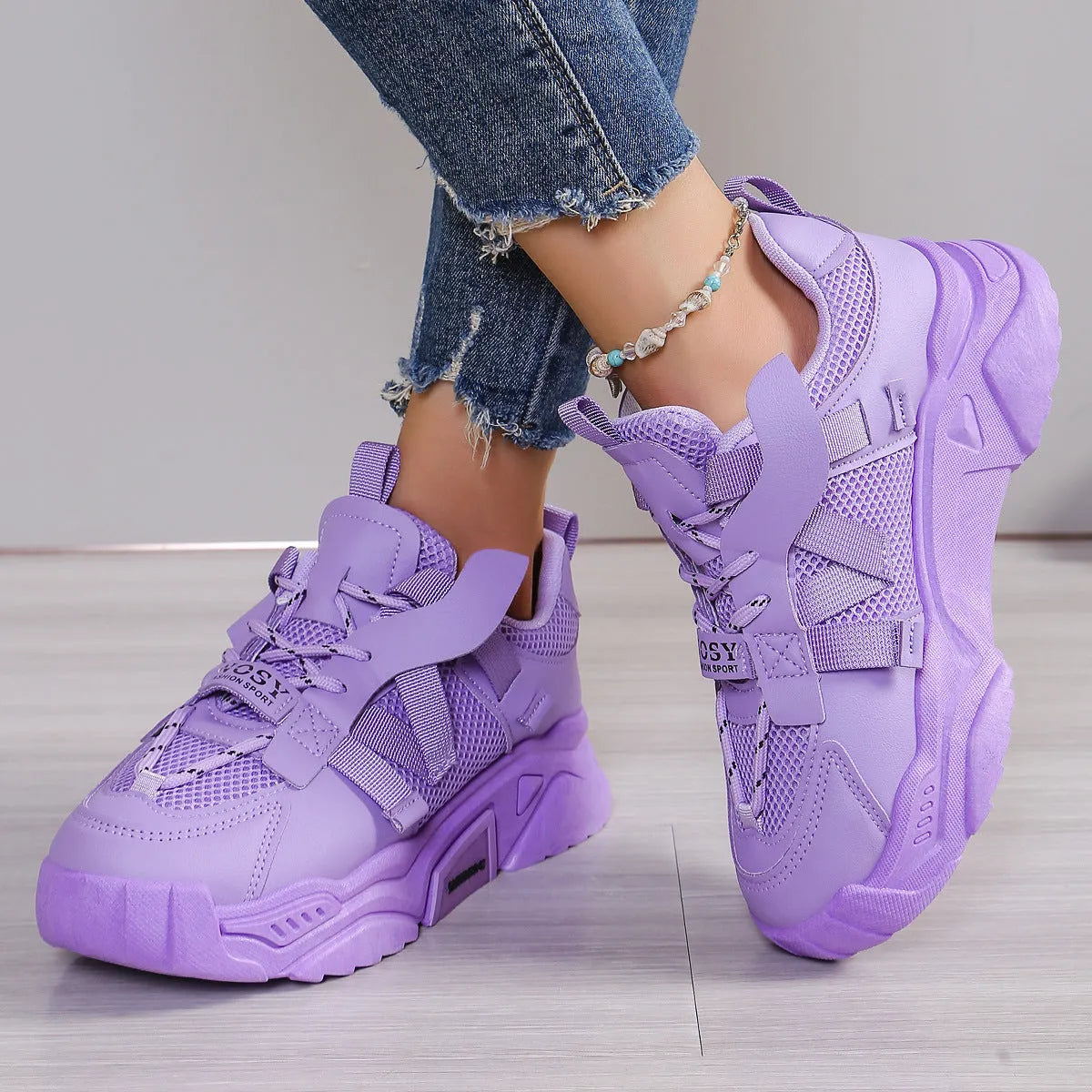 Women's platform mesh dad sports trainer in animal pattern, showing lace-up front and height-increasing sole.