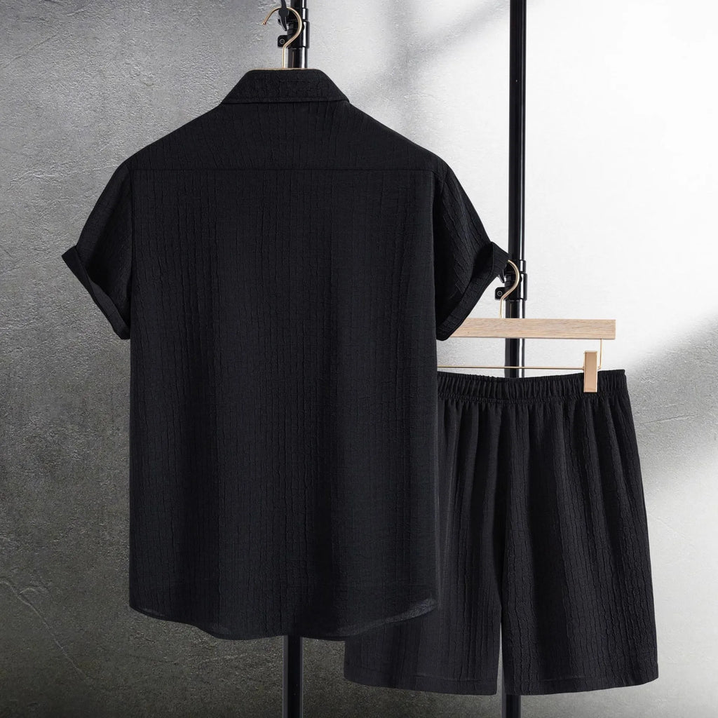 Men's white jacquard cotton blend short sleeve shirt and matching shorts laid flat.