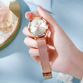 Women's rose shell case fashion watch with mesh strap, showing multiple dial colour options.