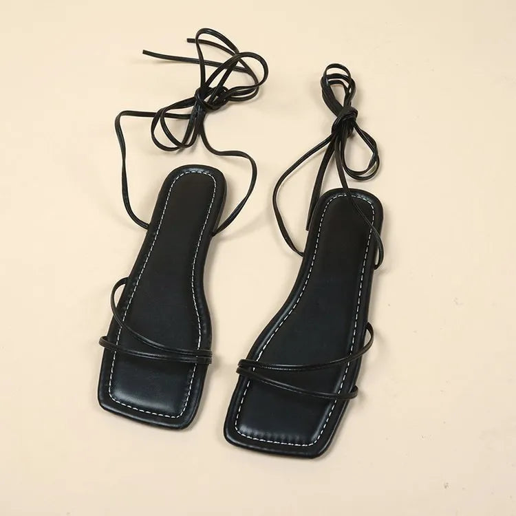 Women's white ankle ring bandage cloth flat sandals with front lace-up and square toe on a rubber sole.