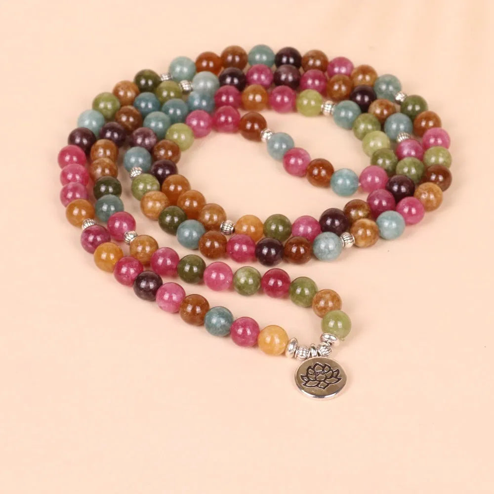 108 bead string bracelet with lotus charm in tourmaline-coloured alloy