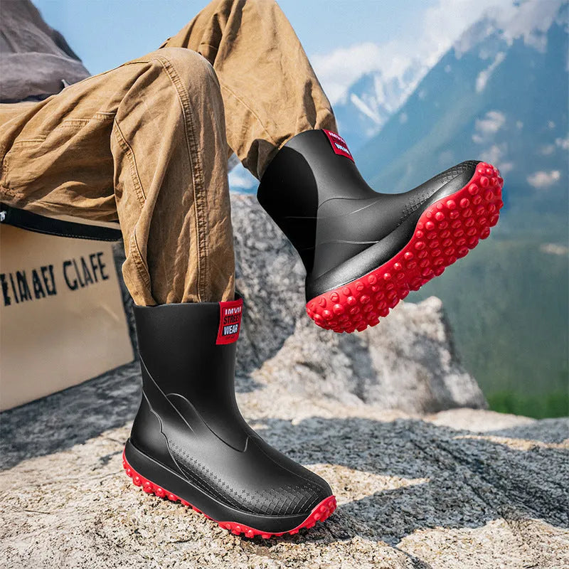 Men's mid tube PVC rain boots in black with non-slip plastic sole, round toe, flat heel