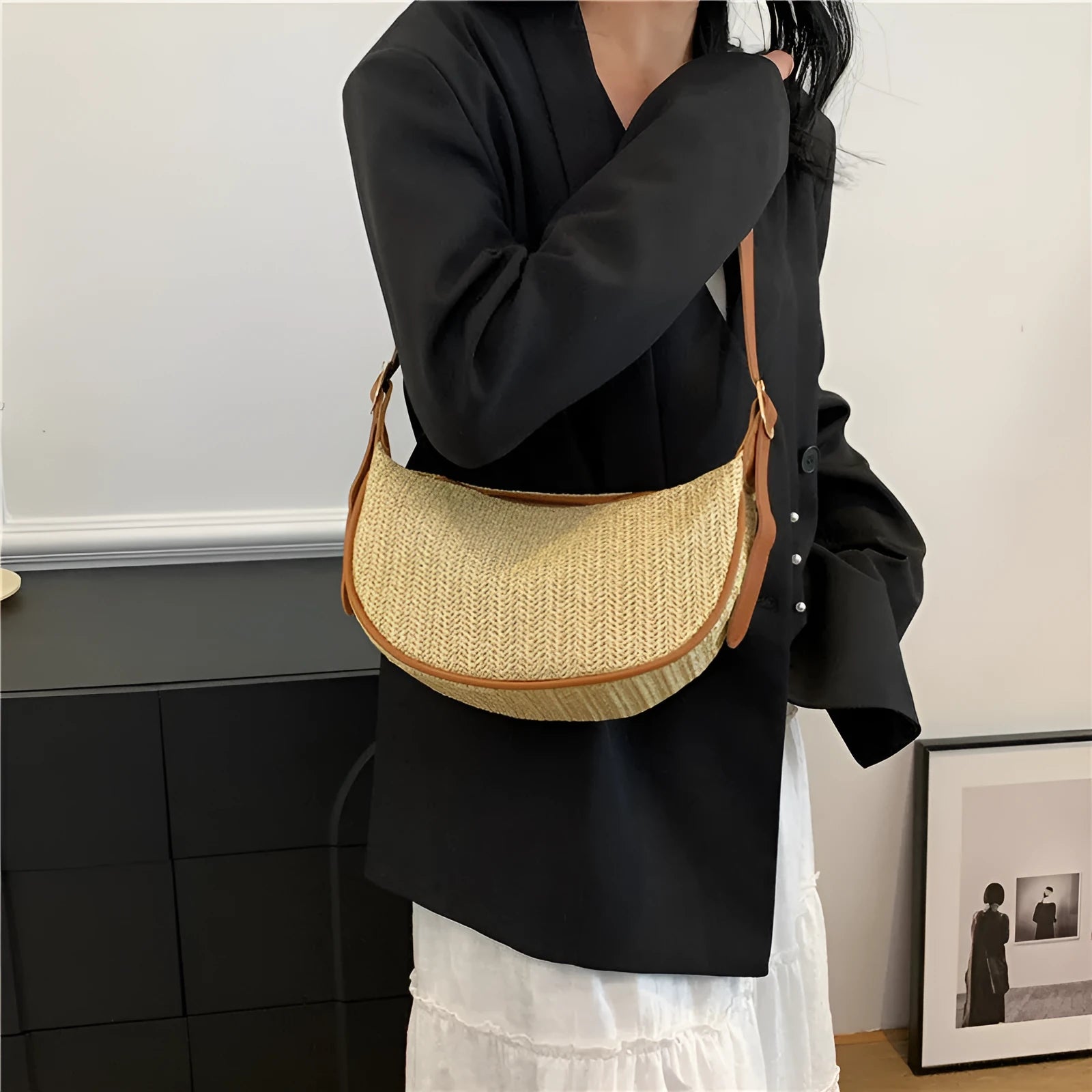 Women's knitted straw woven crossbody bag showing woven texture and internal phone compartment