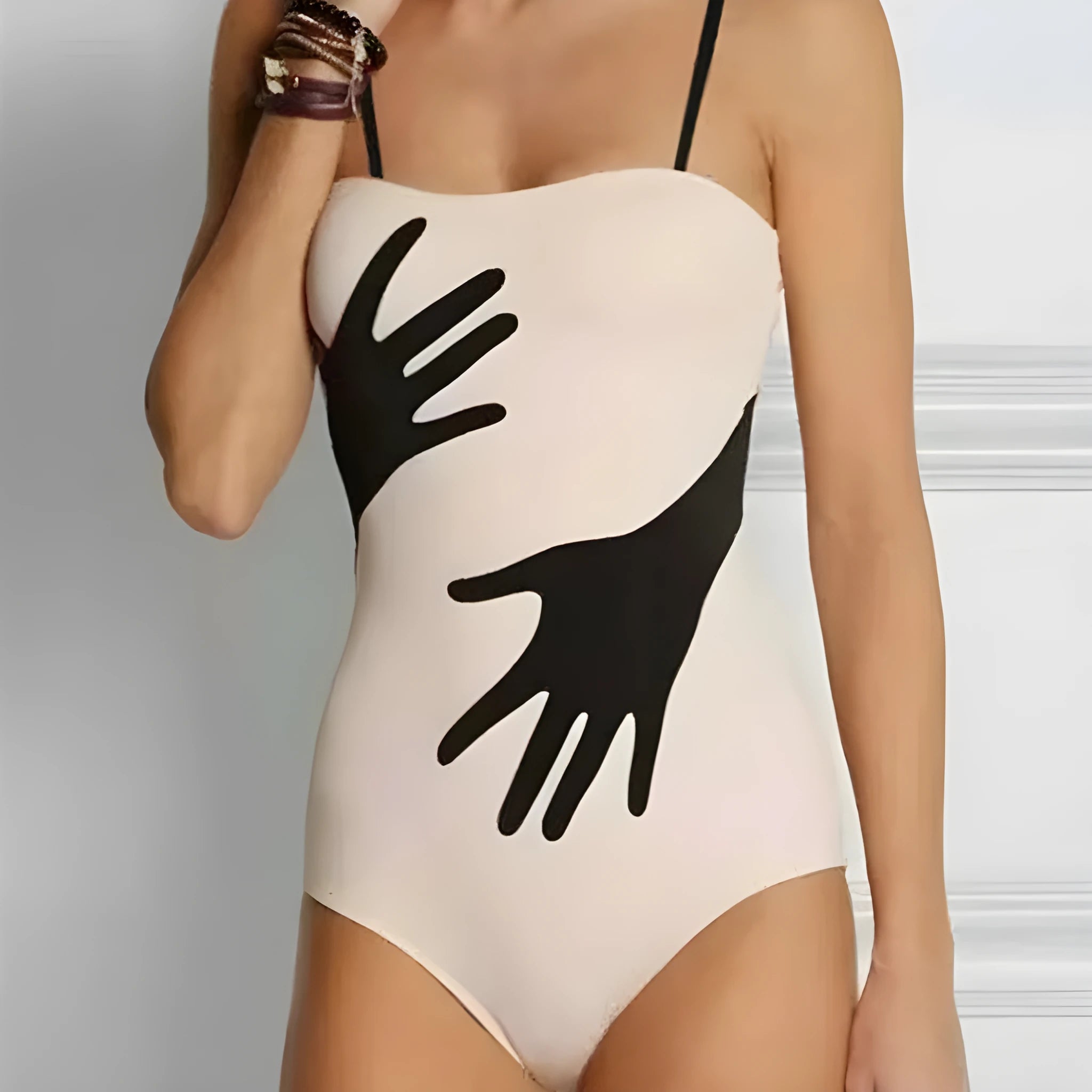Women's one-piece bikini swimsuit with gauze skirt detail on beach