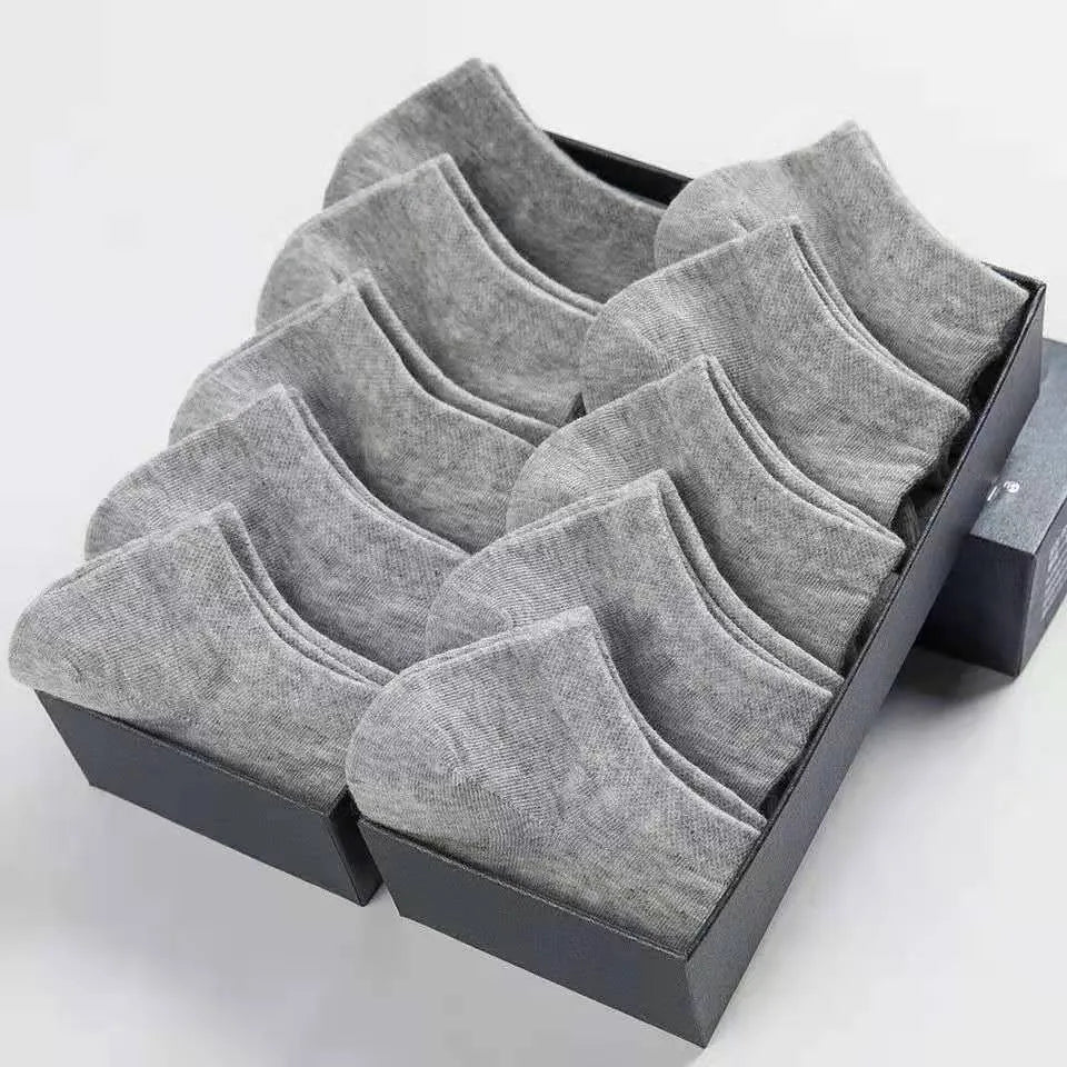 Solid colour men's low cut socks in black, grey, and white with seamless toe construction and blended fabric for breathability.