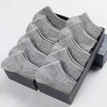Solid colour men's low cut socks in black, grey, and white with seamless toe construction and blended fabric for breathability.