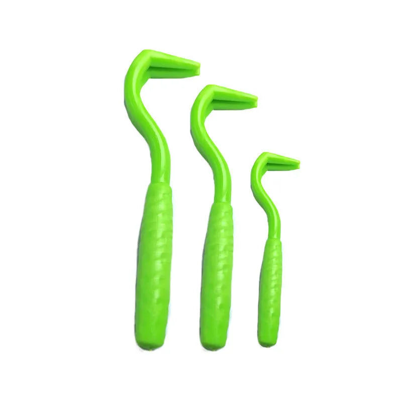 Set of three coloured plastic tick hook removal tools for dogs on a white background.