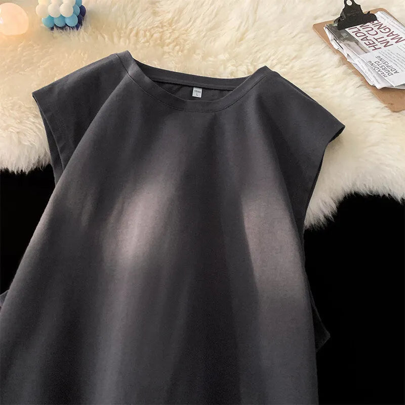 Men's loose-fitting solid colour cotton tank top on a hanger, shown in a light colour.