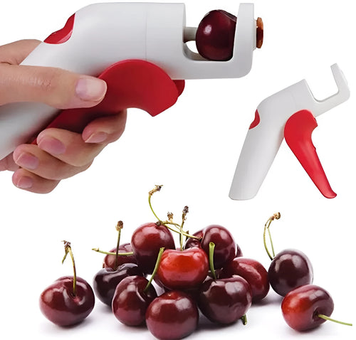 Close-up of a handheld cherry pitter with a plastic handle and stainless steel pitting mechanism