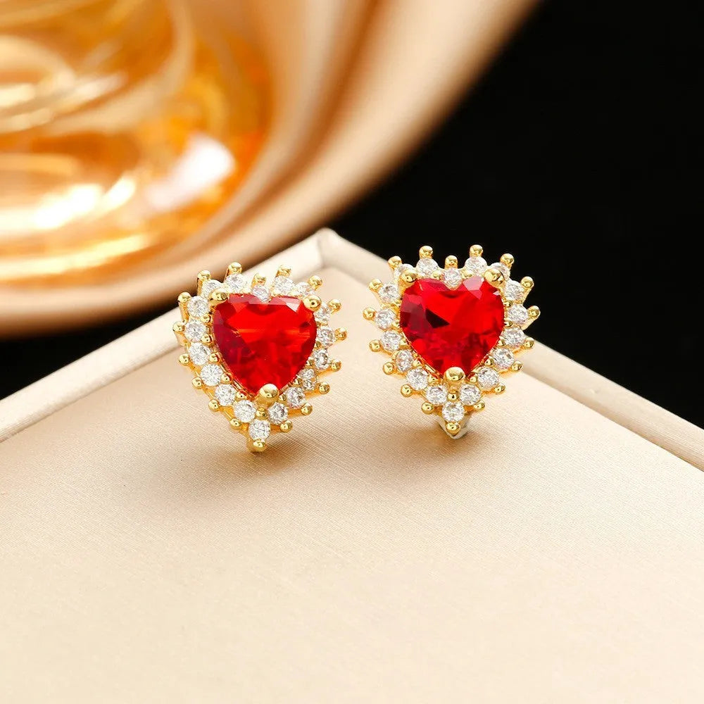Gold red titanium steel necklace, earrings, and ring set with heart flower pendants and gem inlays.