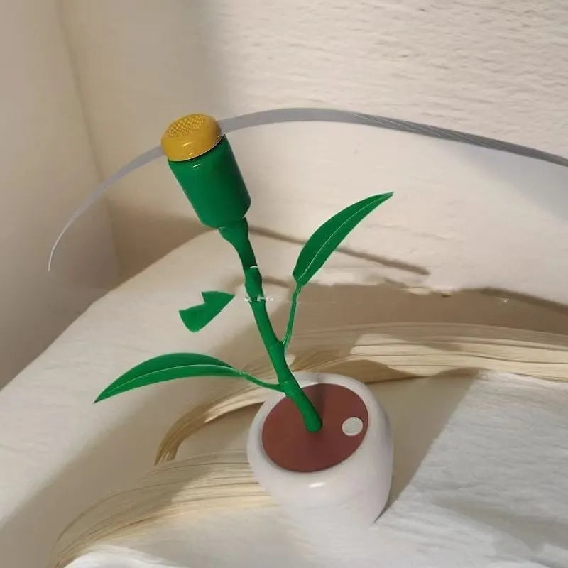 White battery fly repellent fan with curved hose and fruit-shaped design on outdoor table