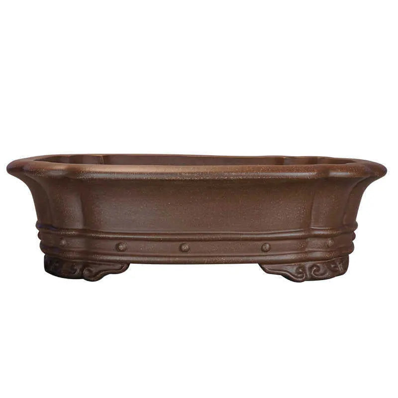 Handmade purple clay rectangular flower pot with antique finish on desktop