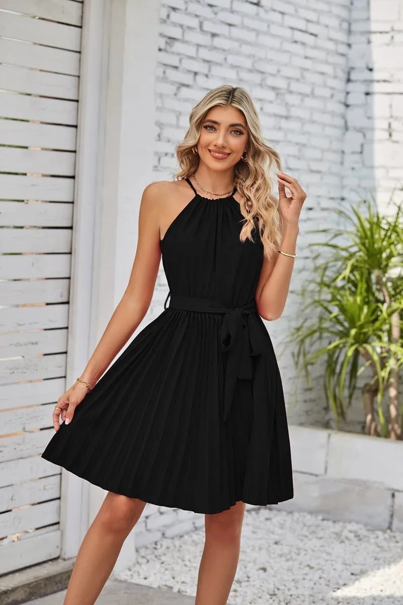 Women's black halter neck strapless sundress with a pleated midi skirt and an adjustable waist belt.