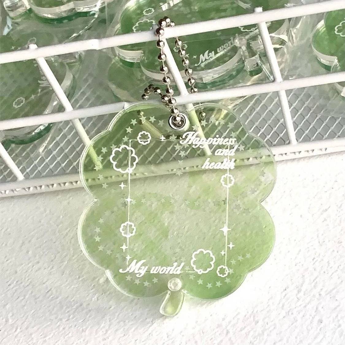 Acrylic four-leaf clover keychain pendant in blue, green, or mint colour options.