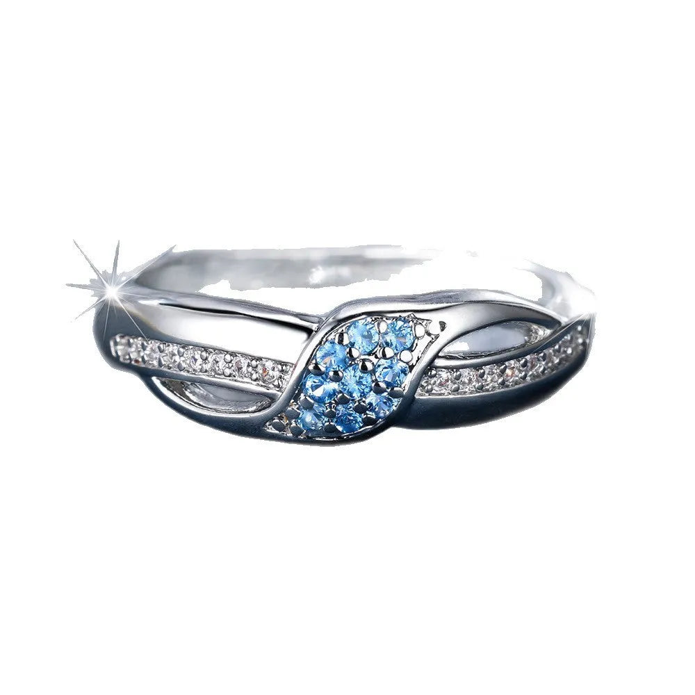 Women's ring with sea blue diamond edge inlay and white diamond leaf accents on white K plated copper band, simple geometric style