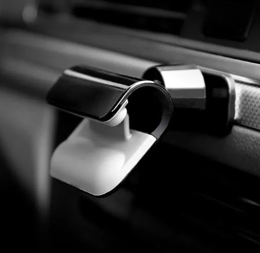 Black universal car phone holder showing 360-degree rotating bracket with 3M adhesive backing