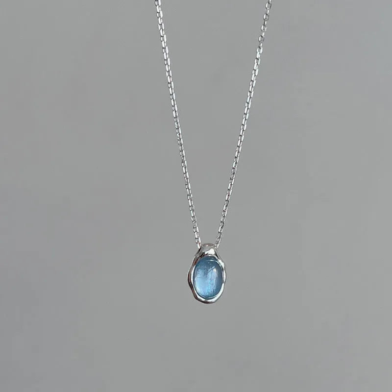 Navy blue water drop pendant necklace with platinum-colour finish on adjustable copper cross chain.