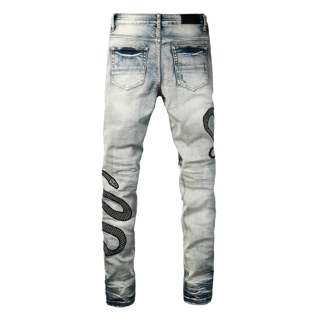 Close-up of wash distressed blue skinny jeans with a button fly and retro styling on a hanger.