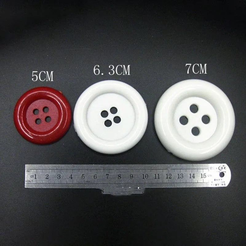 Assortment of oversized round plastic buttons in various colours with four holes.
