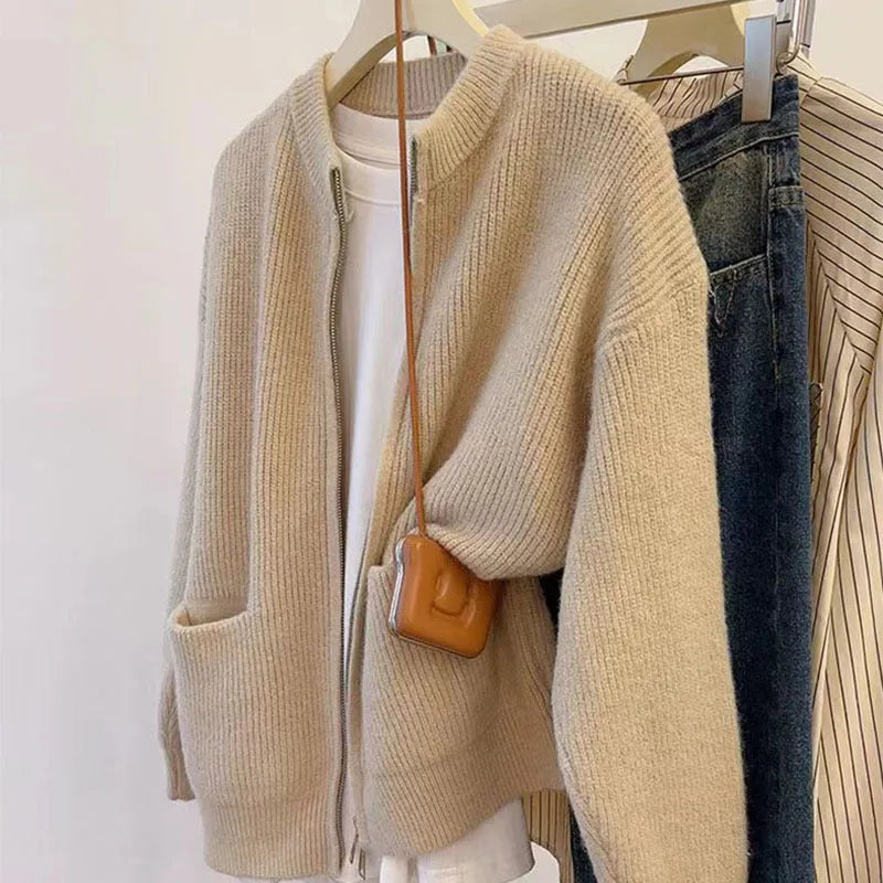 Beige women's long sleeve soft glutinous sweater coat cardigan laid flat.
