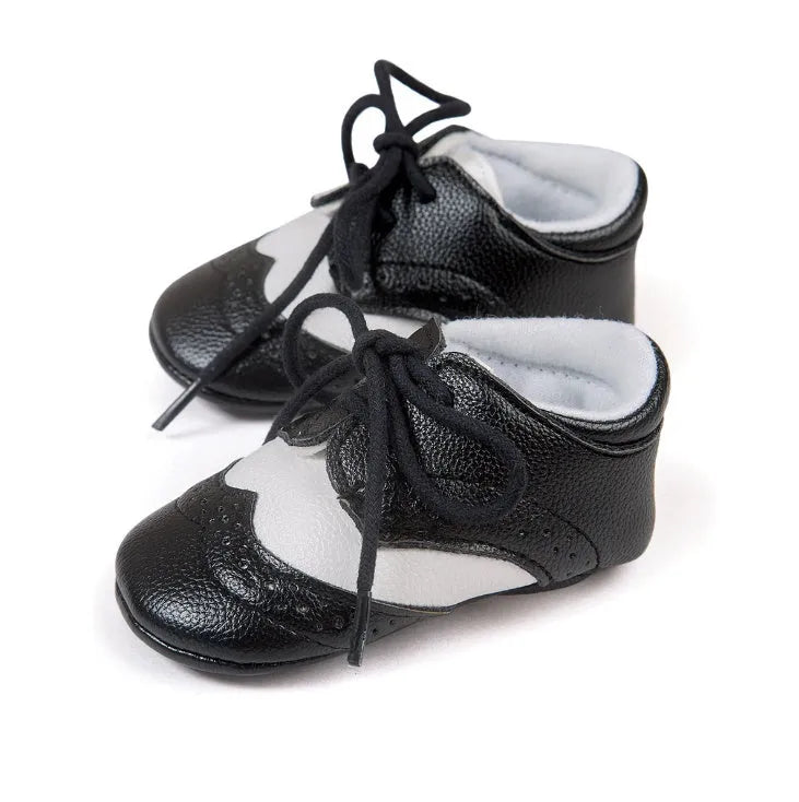 Vintage-style soft-soled baby shoes in synthetic leather with plain pattern design