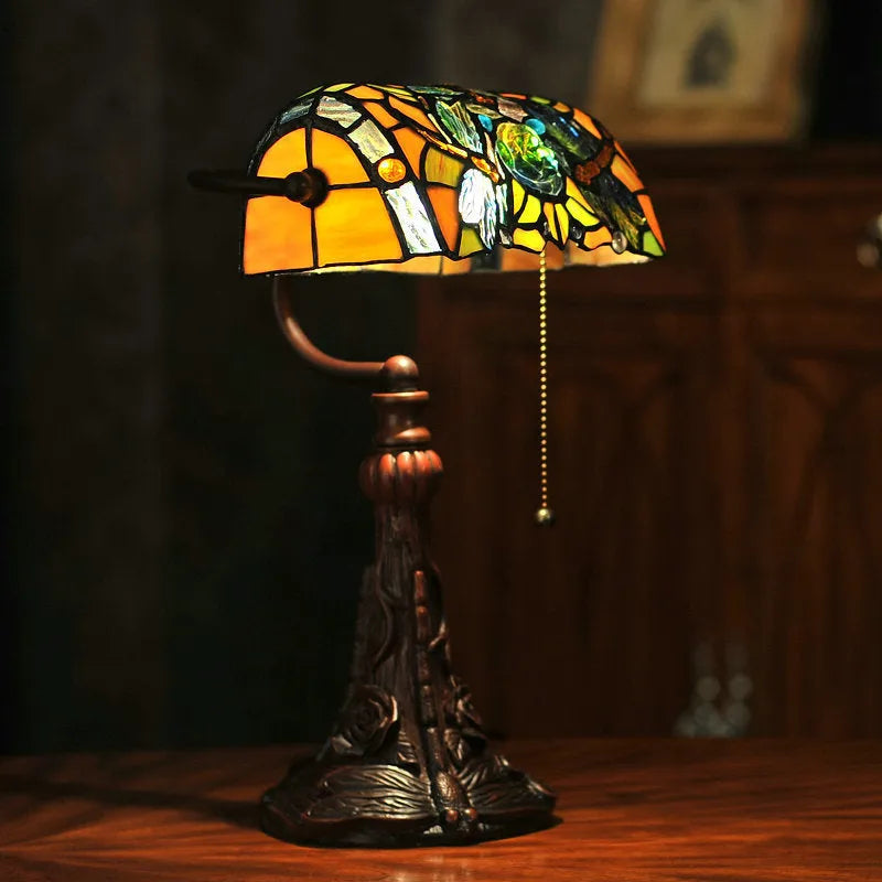 10-inch Tiffany stained glass table lamp with resin base on a wooden desk.