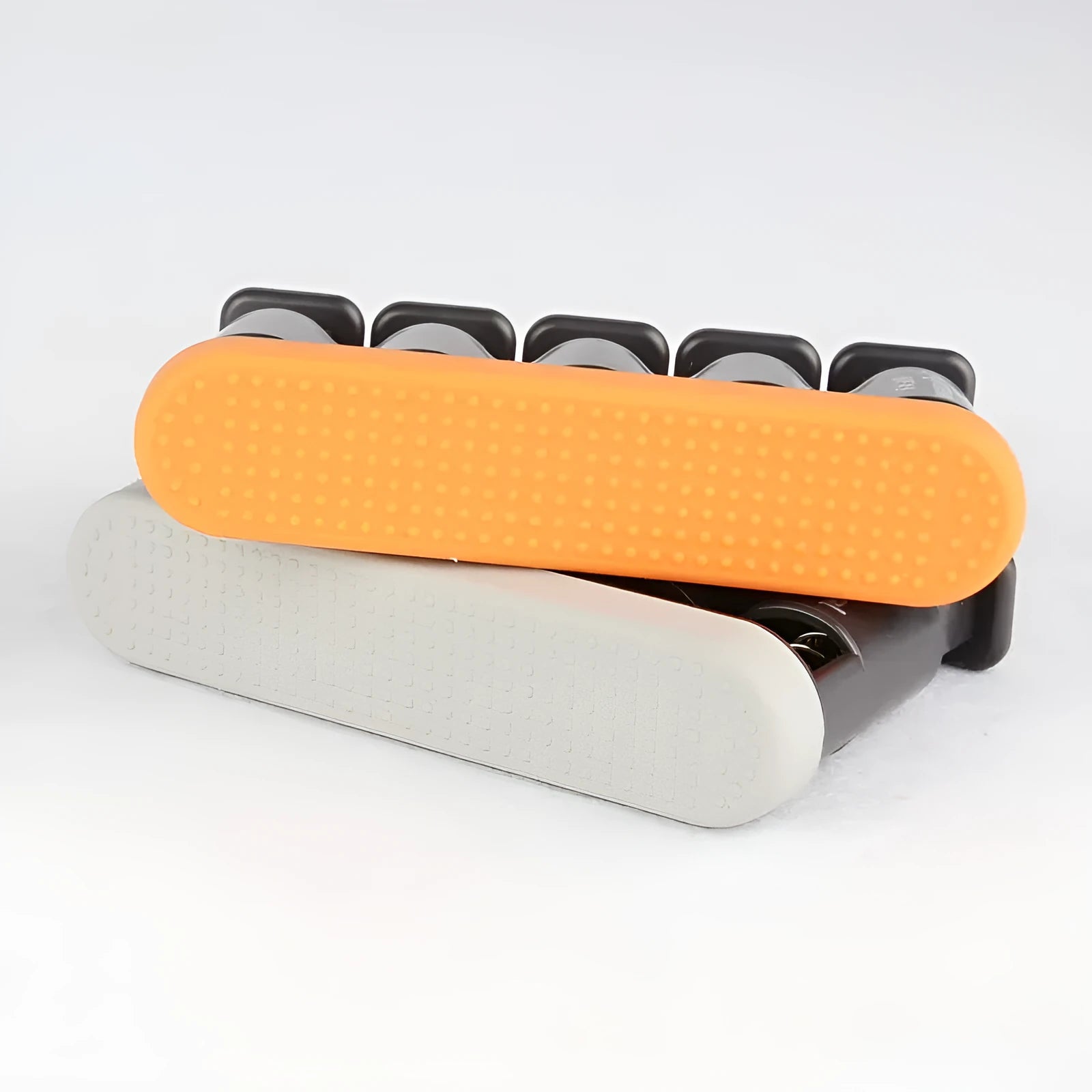 Grey and orange silicone finger exercise tool for musicians and climbers.