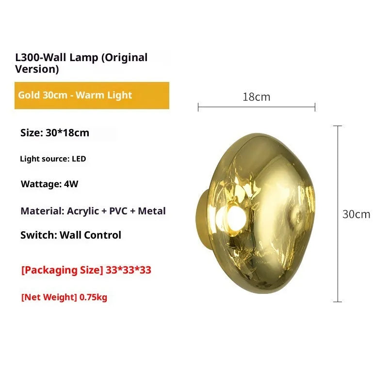 Modern lava wall lamp with acrylic shade in gold finish on a corridor wall emitting warm light