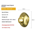 Modern lava wall lamp with acrylic shade in gold finish on a corridor wall emitting warm light