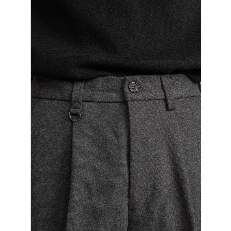 Man wearing grey straight leg polyester trousers for a smart casual look.